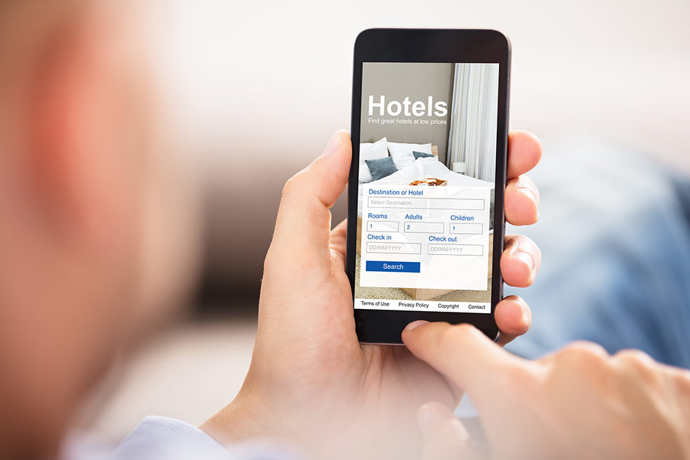 Person on smartphone looking at hotel landing page