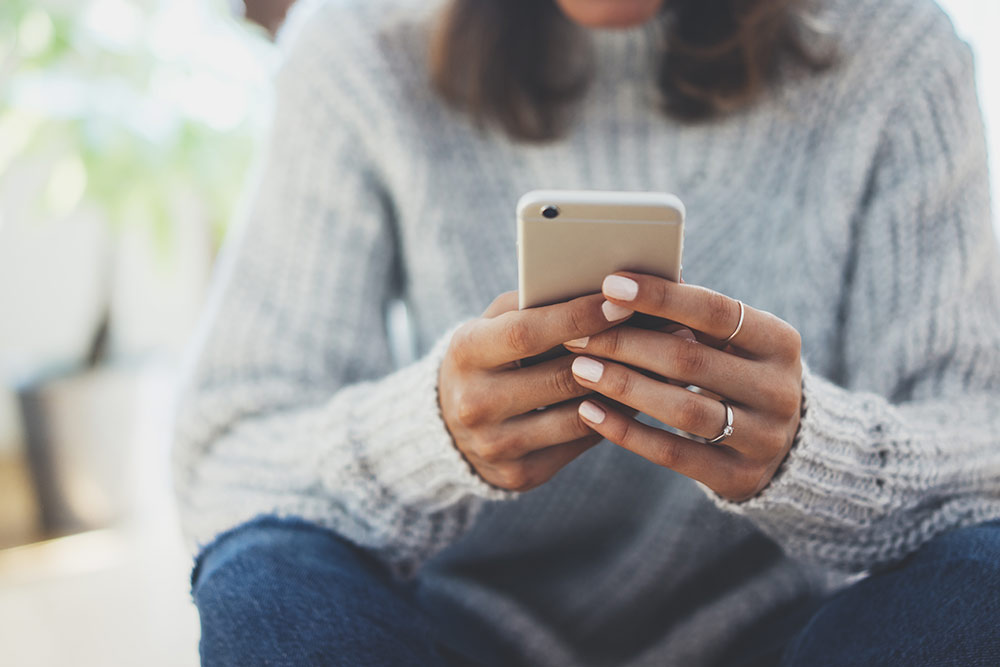 Woman sitting down on smartphone