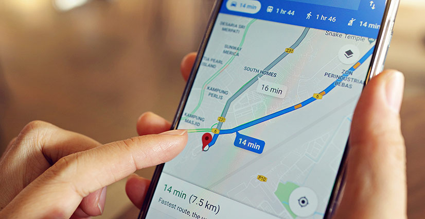 Person on smartphone on Google Maps looking up directions