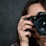 A woman taking social media marketing photos with a camera