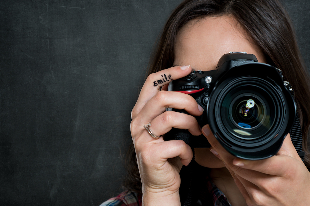 A woman taking social media marketing photos with a camera