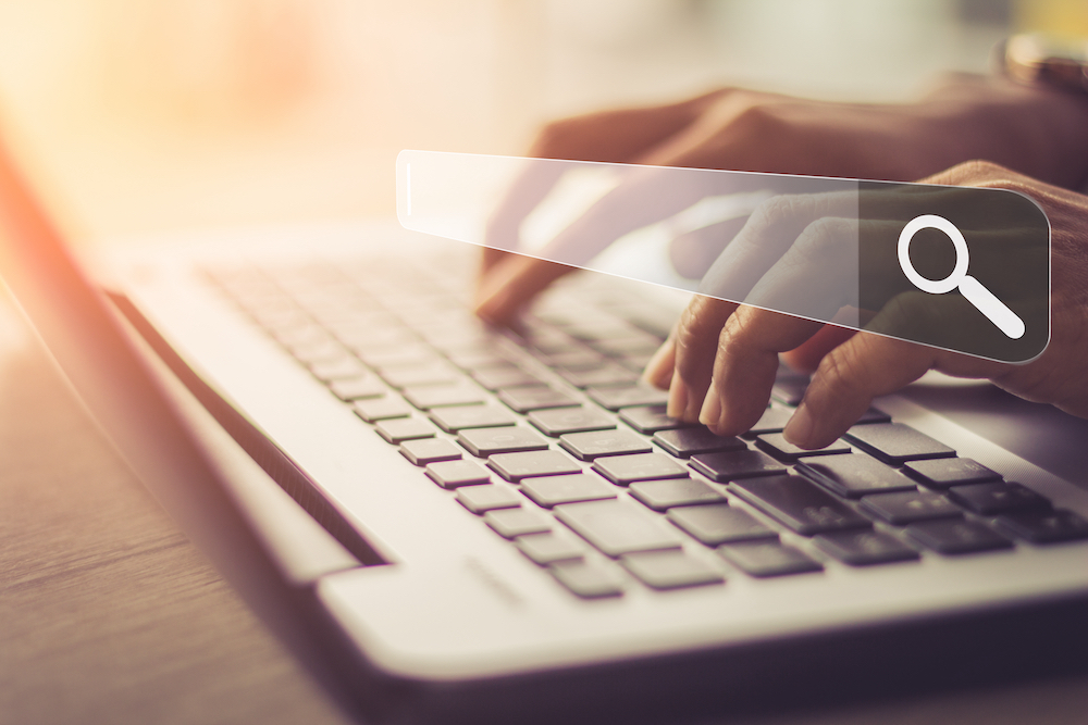 A woman uses her laptop to search the web