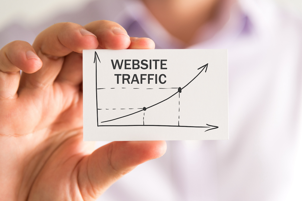 A man holding a chart with increased web traffic