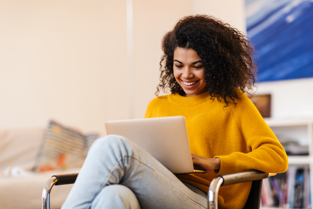 A woman using her computer for SEO purposes