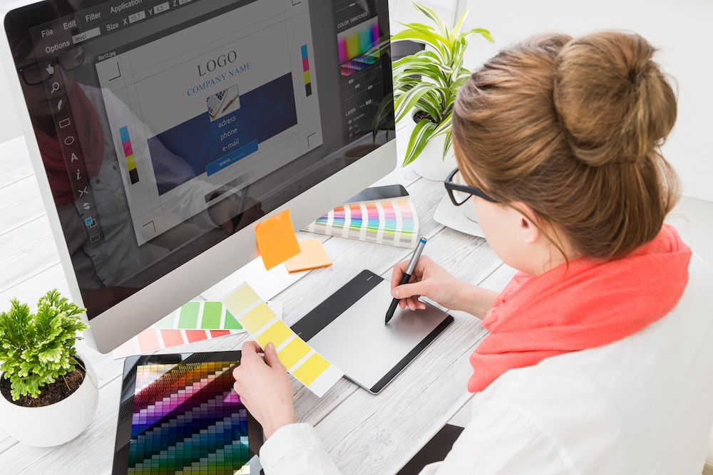 A graphic designer working on designs for collateral branding services