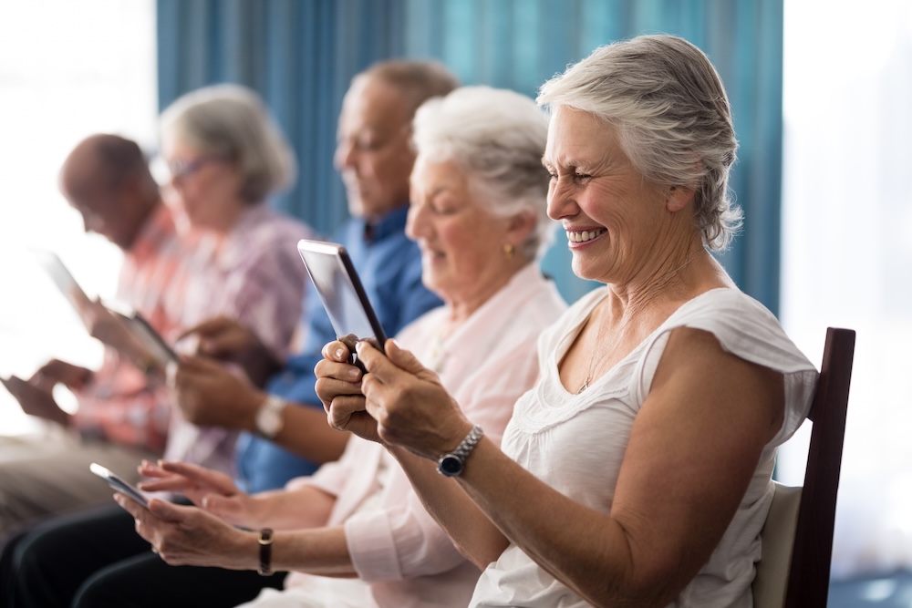 Seniors inside looking at Mobile Optimization Assisted Living Website Designs 